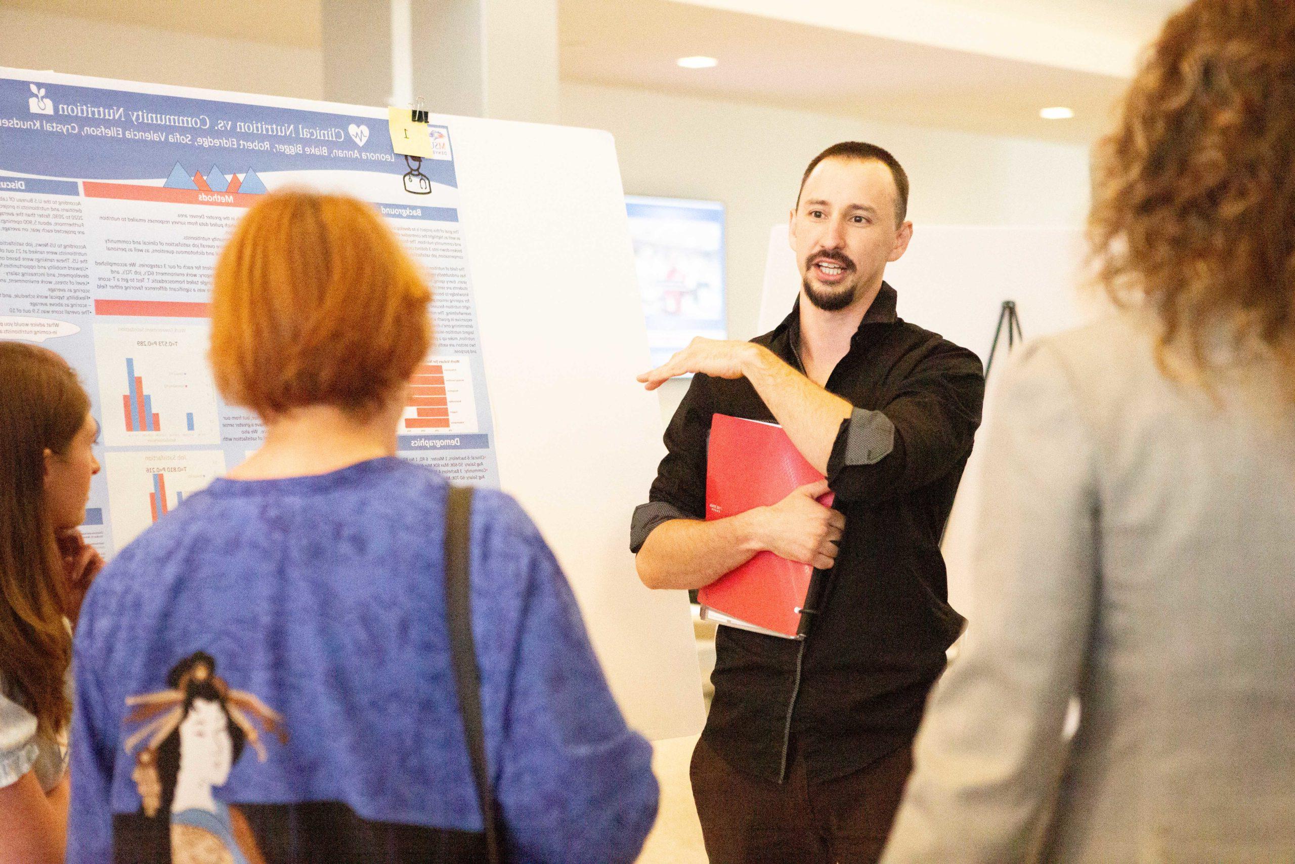 Student presenting to faculty at a conference