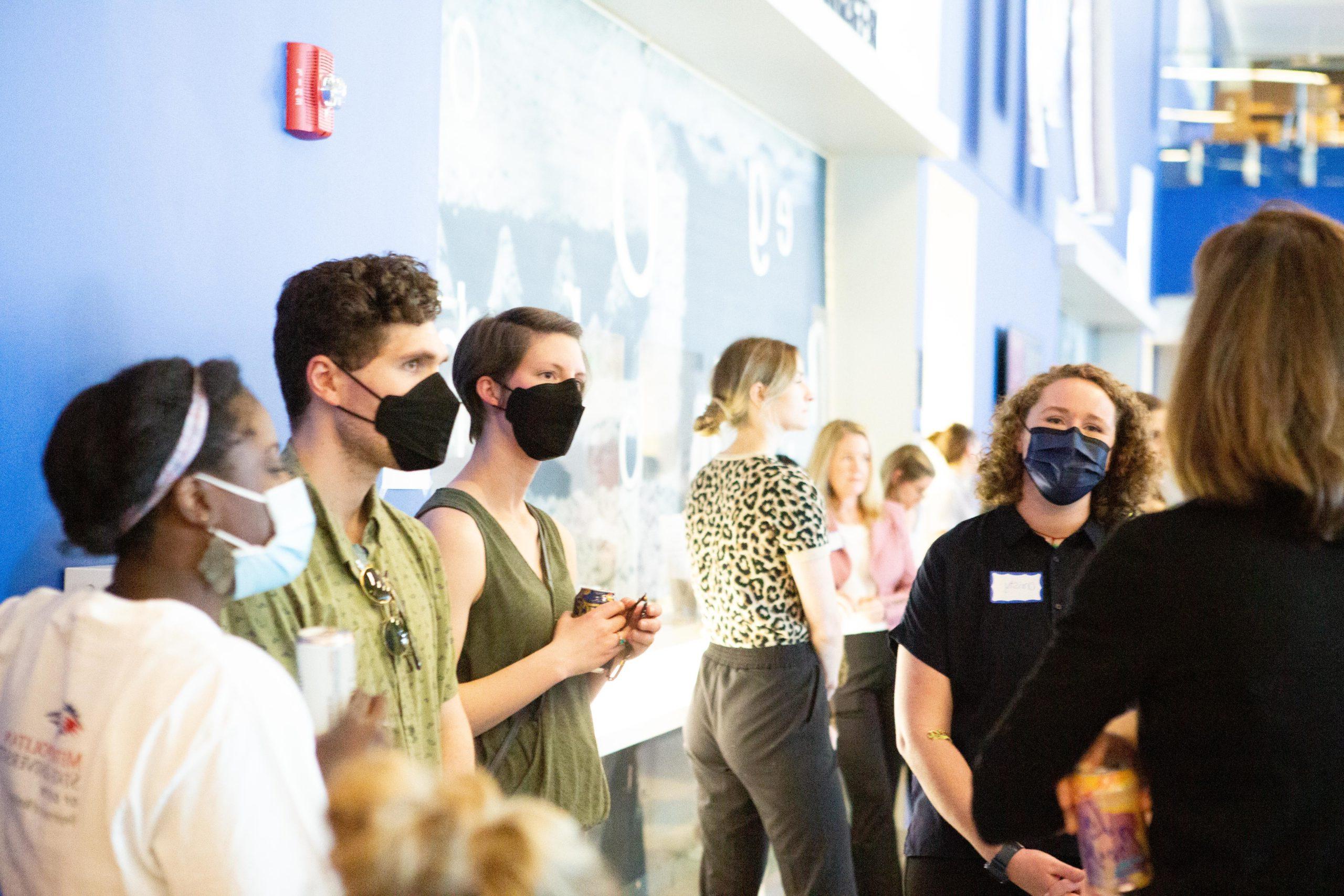 Students and faculty members talking at a conference